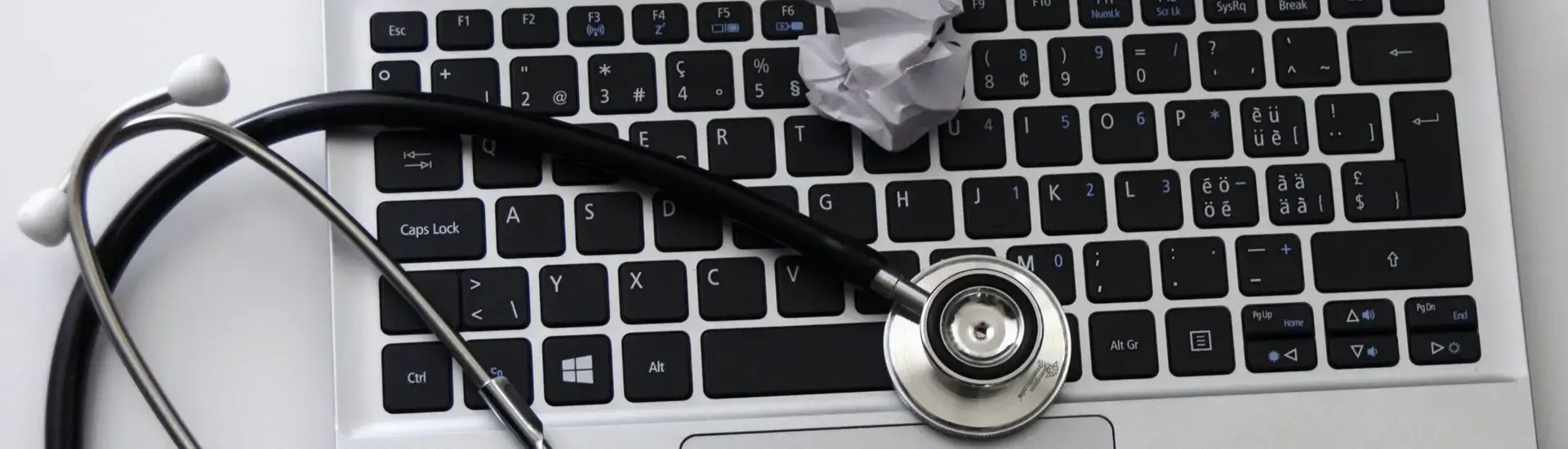 Stethoscope resting on a laptop keyboard